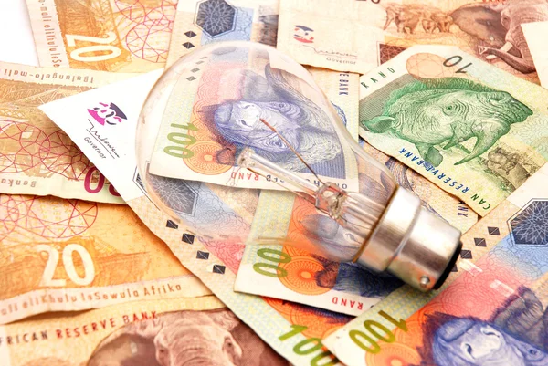 Light bulb on money — Stock Photo, Image