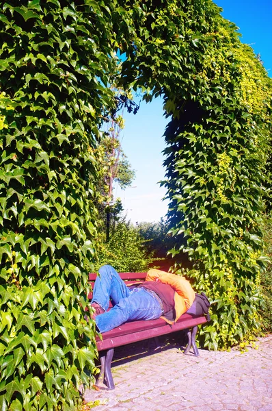 ベンチで寝ているホームレスの男性 — ストック写真