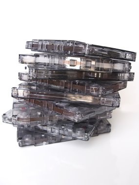 A pile of old fashioned cassette tapes, isolated in white clipart