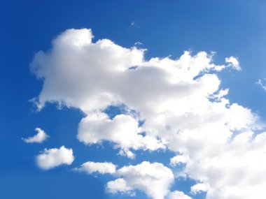 Blue sky with fluffy white clouds in day light clipart