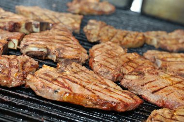 T-bone steak cooking on an open flame grill clipart