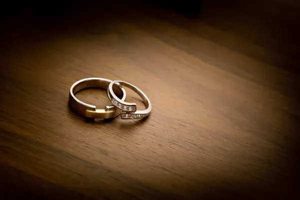 Wedding rings on a wooden background Stock Image