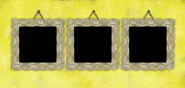 Three ancient empty frames hanging on the wall clipart