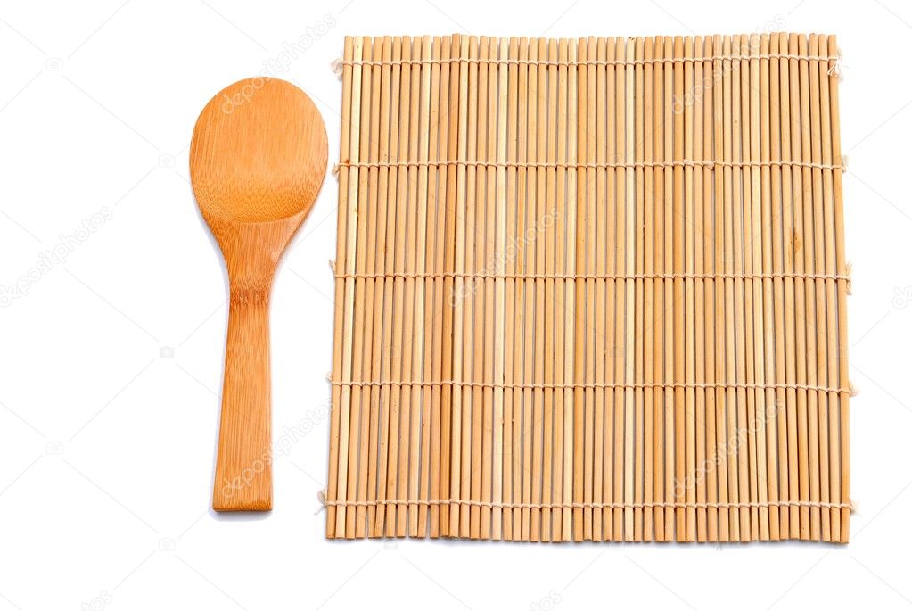Wooden spoon beside bamboo placemat
