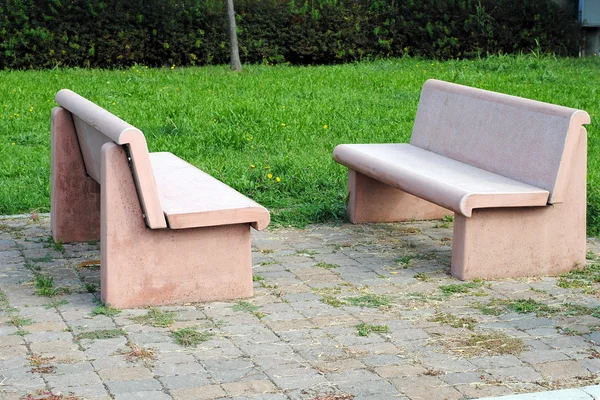 Two pink bench in a park, made of stone — Stock Photo, Image