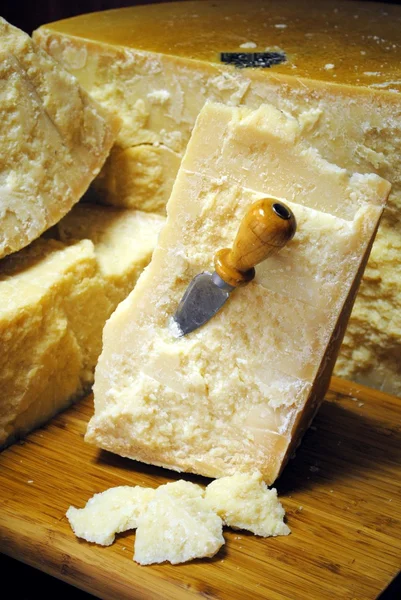 Italiaanse Parmezaanse kaas met mes op houten snijplank Stockfoto