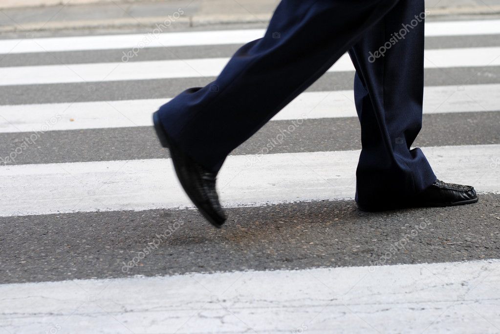 Classic urban zebra crossing with business man feet