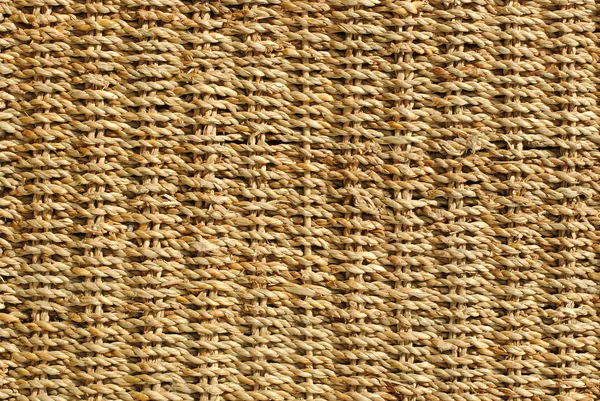 Wicker basket with original pattern, straw background — Stock Photo, Image