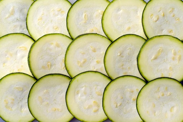 Slices of courgette, upon the others, as background — Stock Photo, Image
