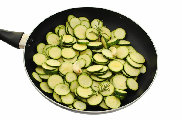 Raw cougrettes with rosemary in frying pan — Stock Photo, Image
