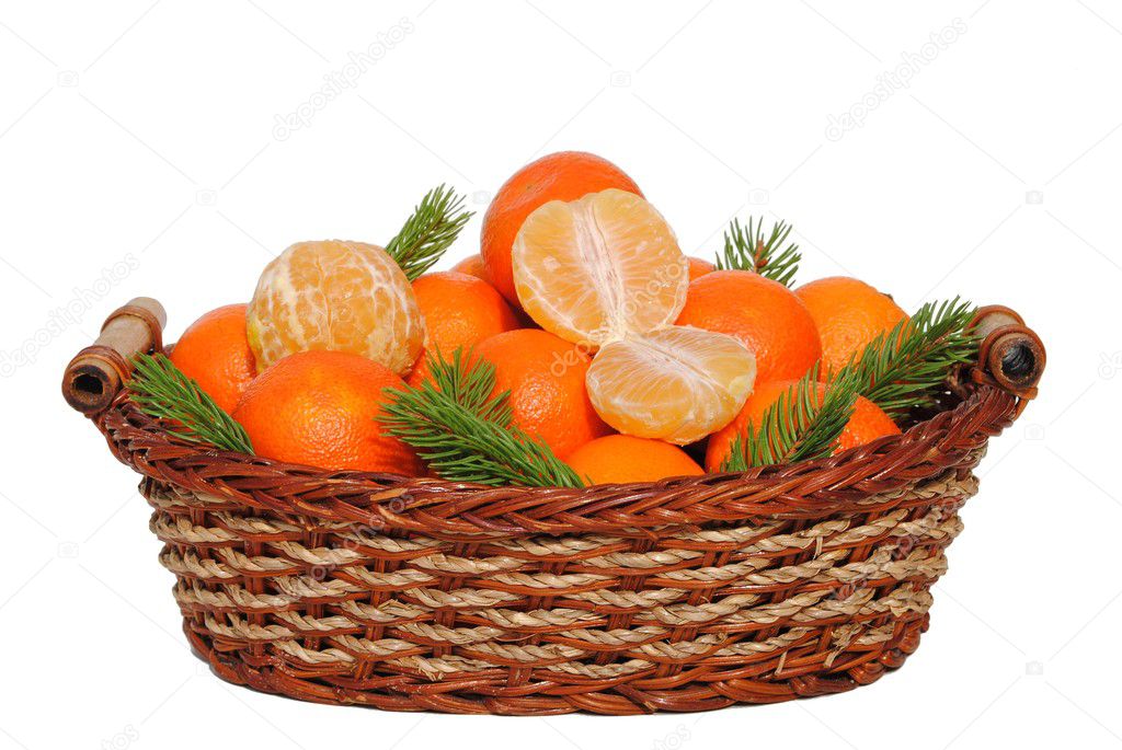 Mandarin in a straw basket isolated on white background