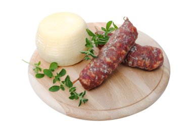 Italian salami and cheese on wooden cutting board clipart