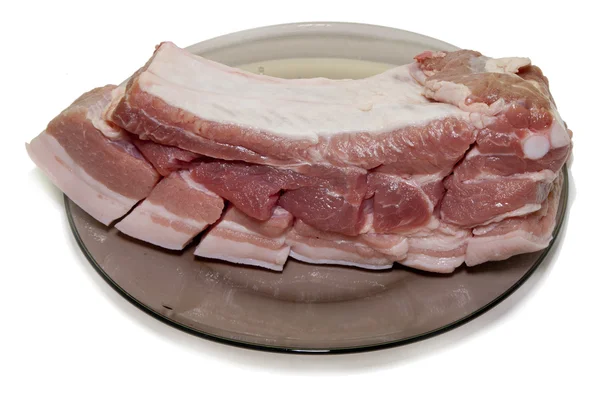 Cerdo fresco en un plato de vidrio — Foto de Stock