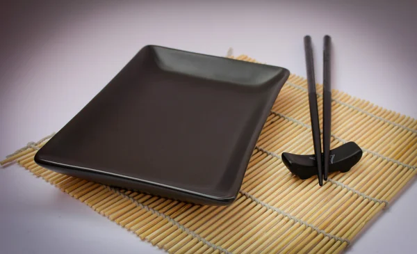 stock image Sushi sticks and black plate