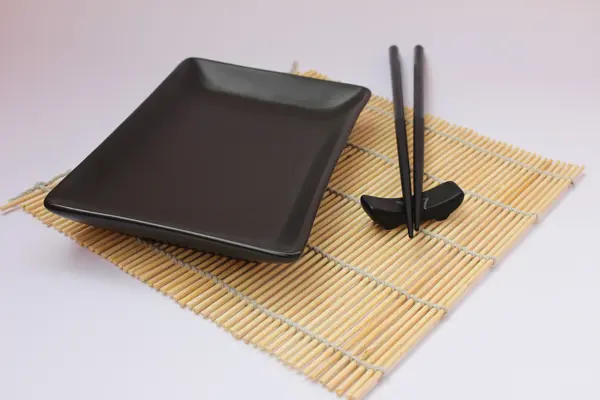 stock image Sushi sticks and black plate