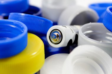 Alkaline battery with bottle caps clipart