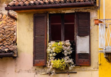 An old balcony with some yellow and white flowers clipart