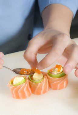 Sushi chef preparing sushi clipart