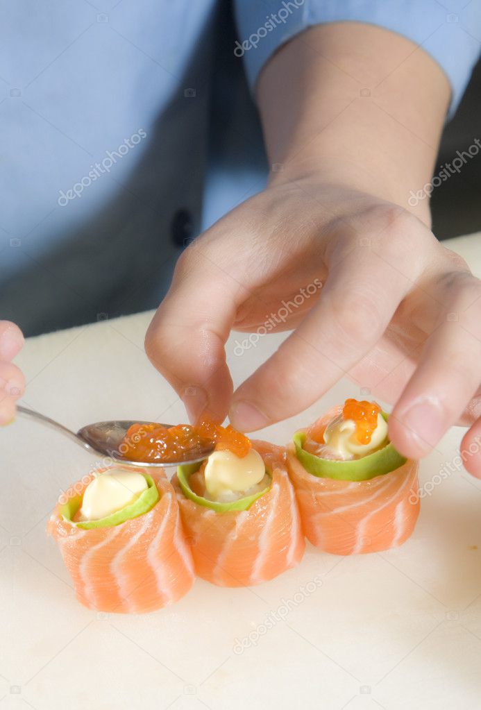 Sushi chef preparing sushi