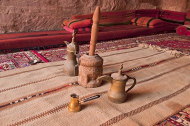 Arabic coffee pots,Grinder in a Bedouin tent clipart