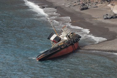 Ship wreck on the coast of Santorini, Greece clipart