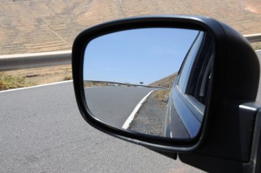 Road in rear view mirror, Fuerteventura Spain clipart