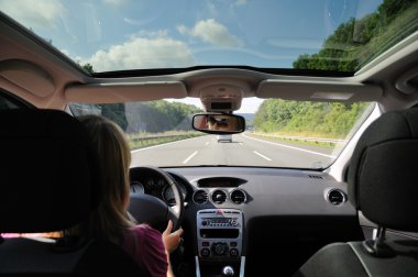 Young woman driving with her car clipart