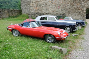 Vintage cars parked at medieval castle, Germany clipart