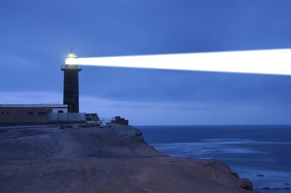 Lighthouse searchlight beam through foggy air — Stock Photo, Image