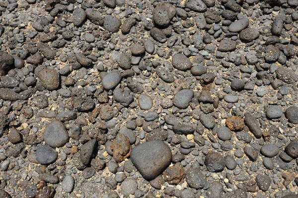 Black volcanic stones on the coast of Canary Island Fuerteventura, Spain — Stock Photo, Image