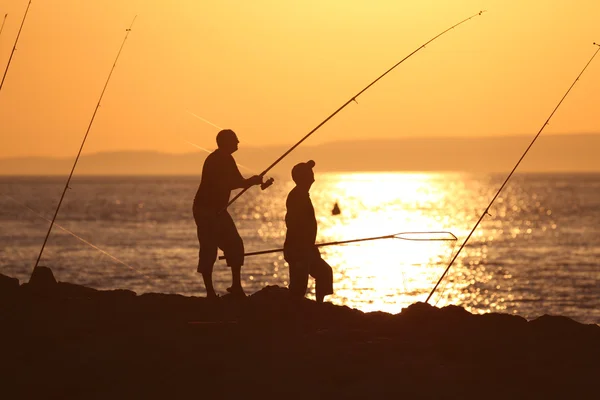 Fishermen in the sunset — Stock Photo, Image
