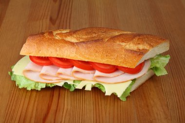 Delicious fresh sandwich with turkey breast, swiss and tomatoes clipart