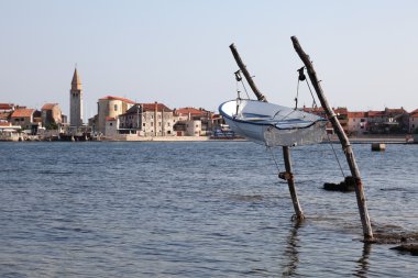 Fishing boat hanging over water, Adriatic Sea coast clipart