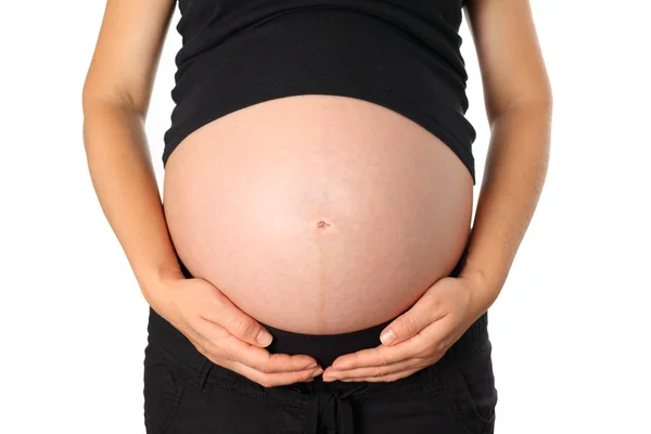 Jeune femme enceinte tient son ventre — Photo
