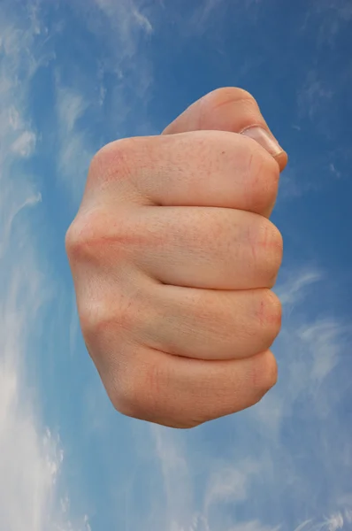 Fist against blue sky — Stock Photo, Image