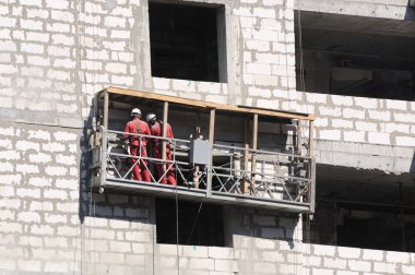 Exterior work at an unfinished building clipart