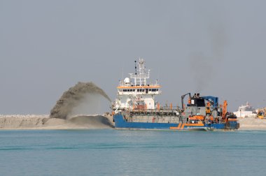 Special dredge ship pushing sand to create new land in Dubai, United Arab E clipart