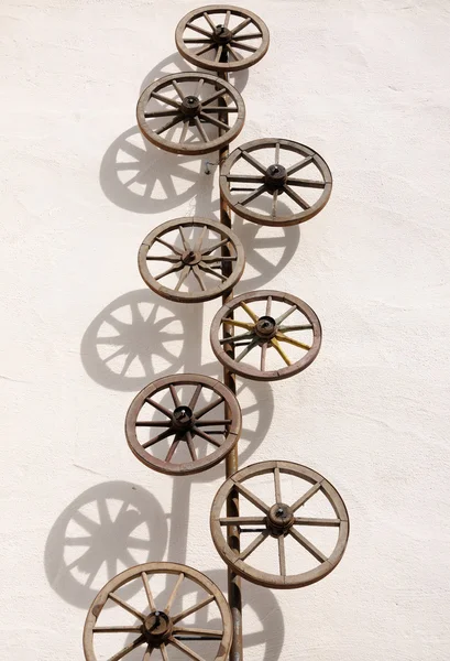 stock image Old wooden wheels on the wall