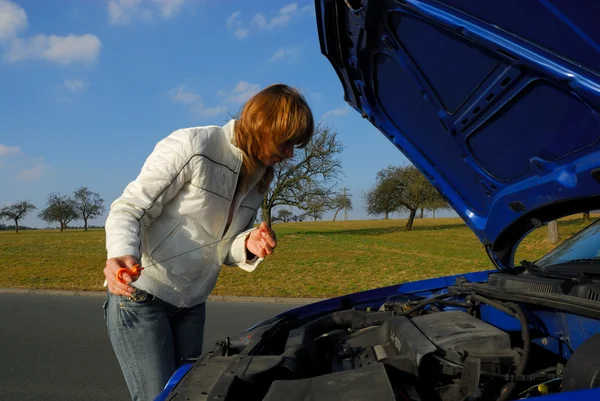 stock image A Woman Checking the Motor Oil in Her Car