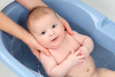 Three month old baby girl bathing clipart