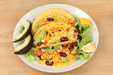 Mexcian food - plate with tacos, lettuce and avocado clipart