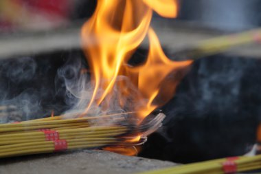 Burning Incense Sticks at Buddhist temple in China clipart