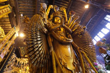 Thousand arms god statue in Longhua temple, Shanghai China clipart