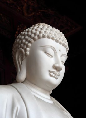 White buddha statue in Longhua temple, Shanghai China clipart