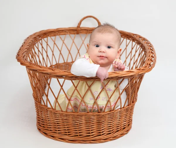 Little baby girl sitting in basket — Stock Photo, Image