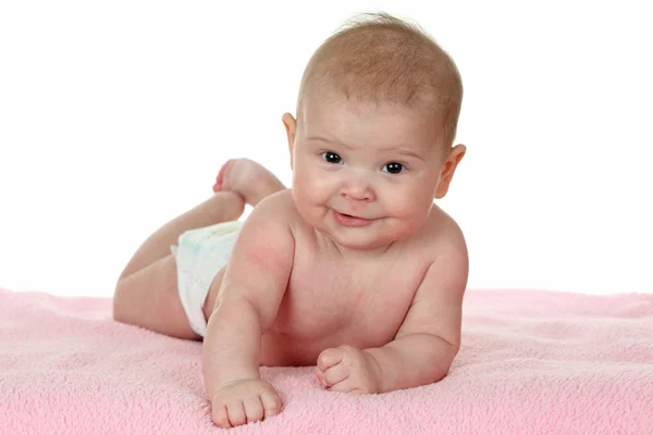 Cute baby girl lying on a pink blanket — Stock Photo, Image
