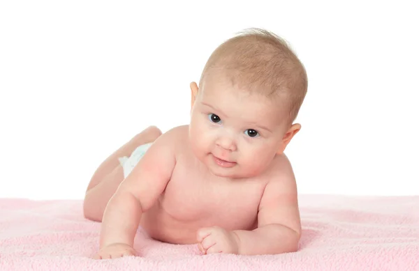 Cute baby girl lying on a pink blanket — Stock Photo, Image