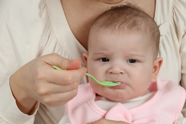 Mother feeds her little baby with spoon — Stock Photo, Image