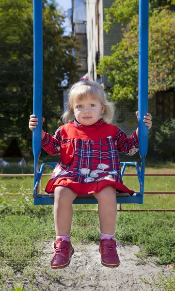 Adorable little girl having fun on a swing — Stock Photo, Image