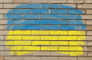 Flag of ukraine on grunge brick wall painted with chalk clipart